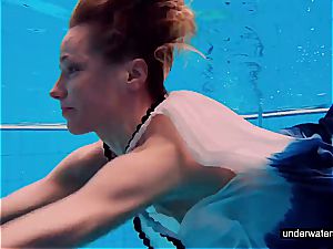 nubile woman Avenna is swimming in the pool